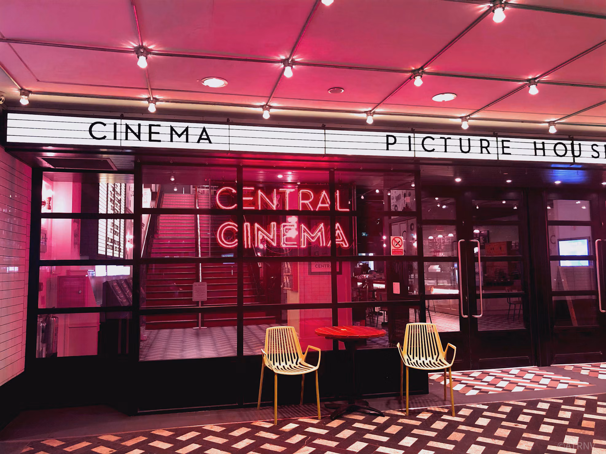 Rows of red seats facing the screen in a darkened cinema