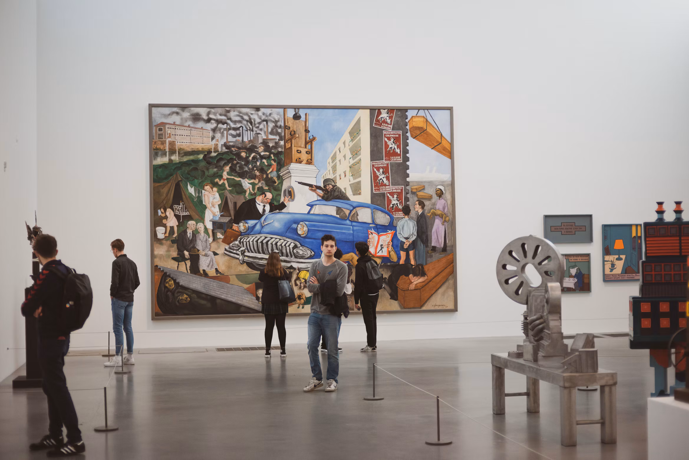 Visitors viewing paintings and sculptures inside Tate Modern in London