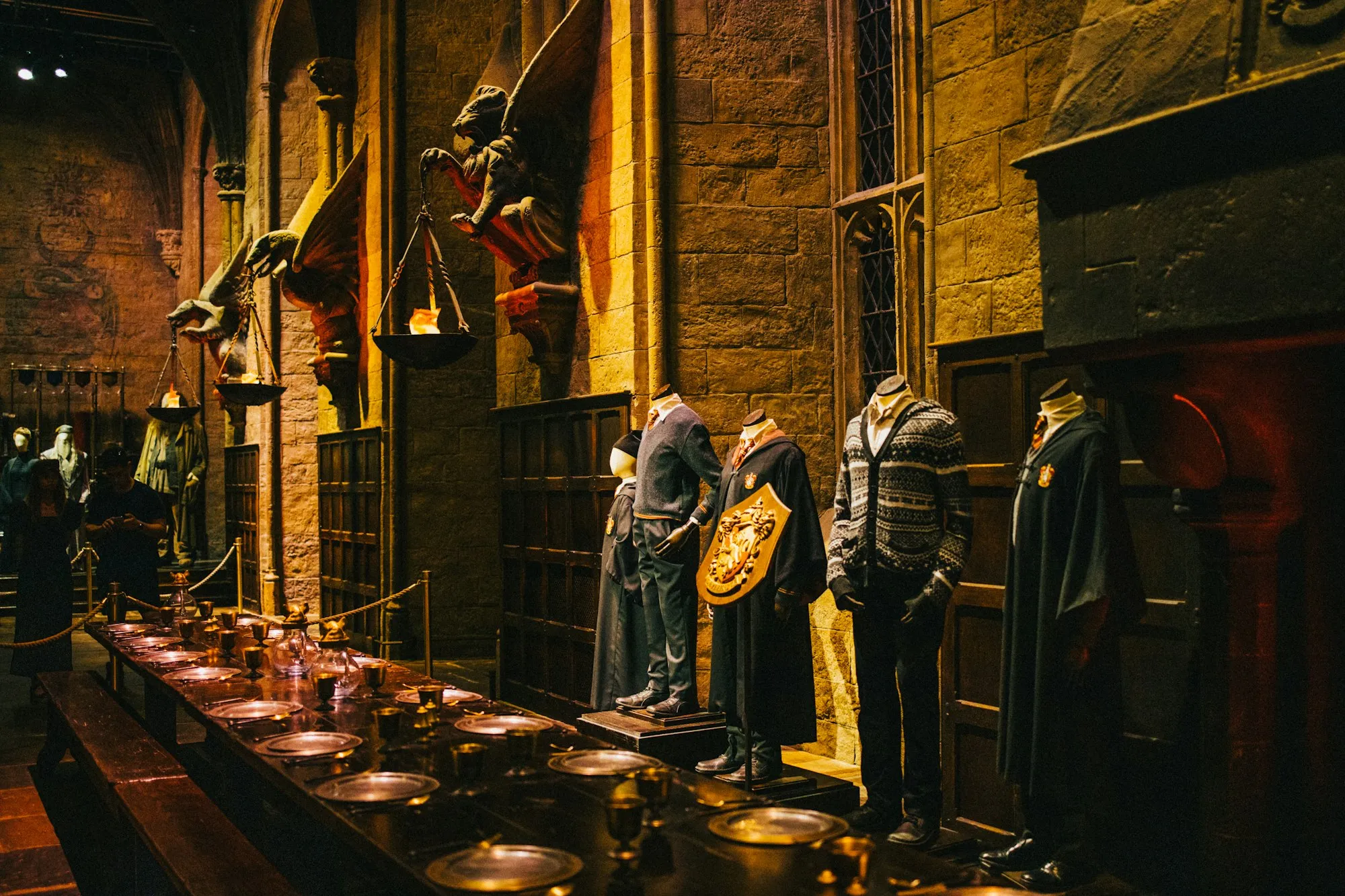 House costumes on display along the Great Hall's dining tables