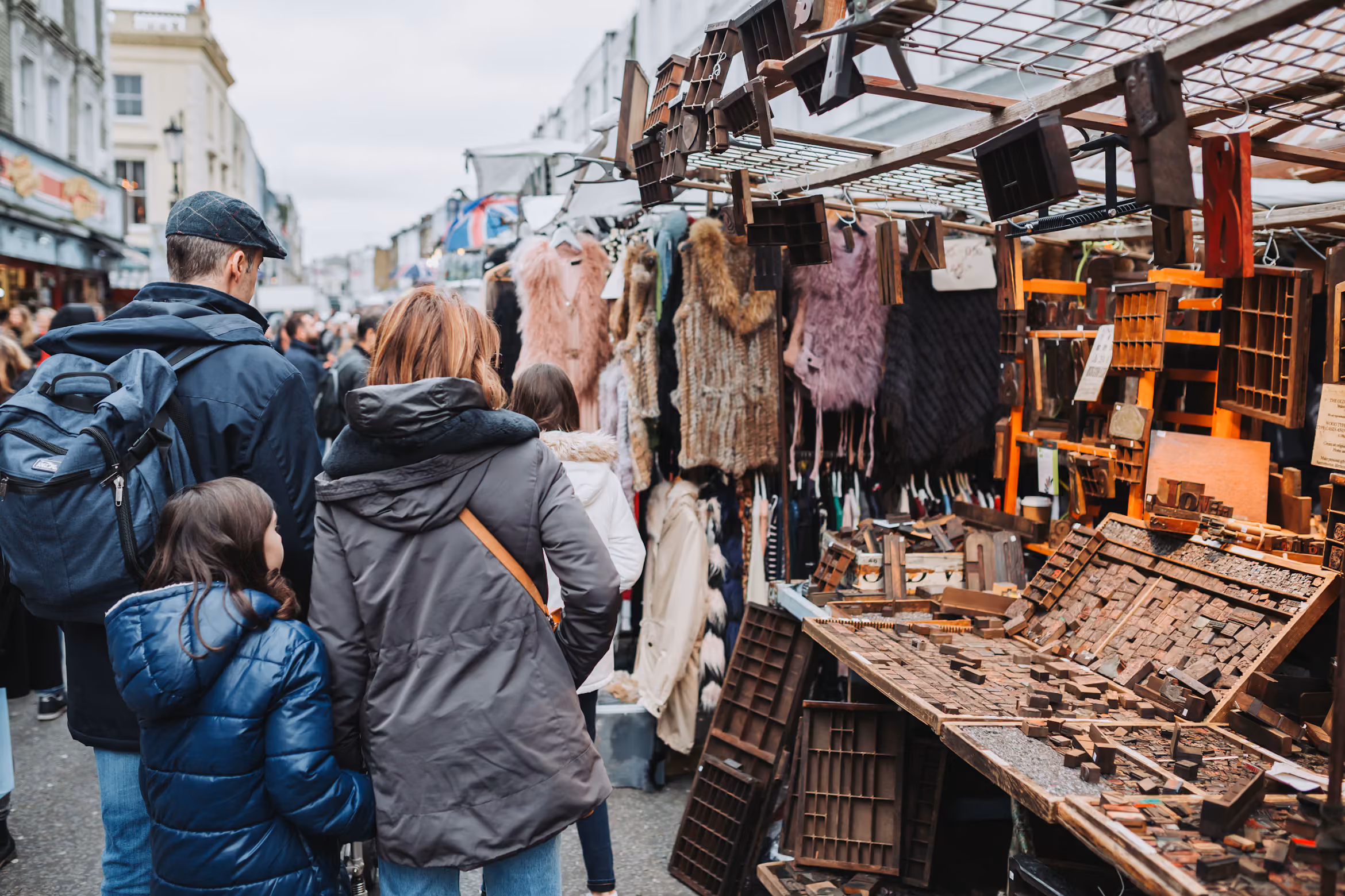 Visitors browsing jewellery and other goods at outdoor stalls on Portobello Road